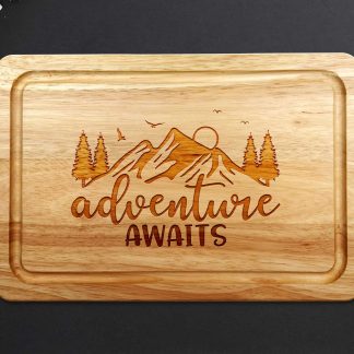 Adventure Awaits Chopping Board on a grey worktop